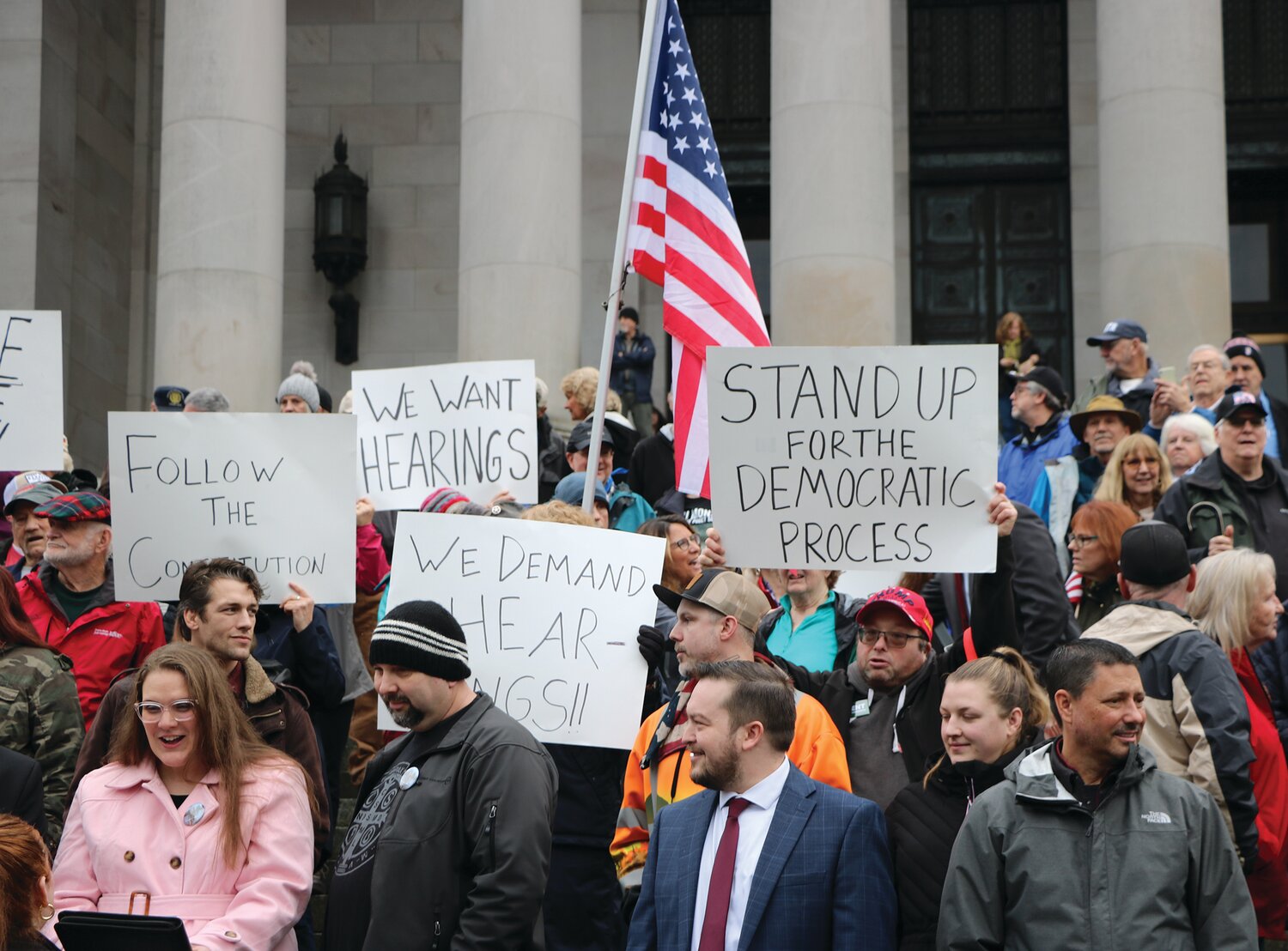 Washingtonians from all over the state gathered on the north steps at the capitol in Olympia, for a rally planned only a week in advance. Protesters displayed signs that read “We want hearings,” and “Follow the constitution.”